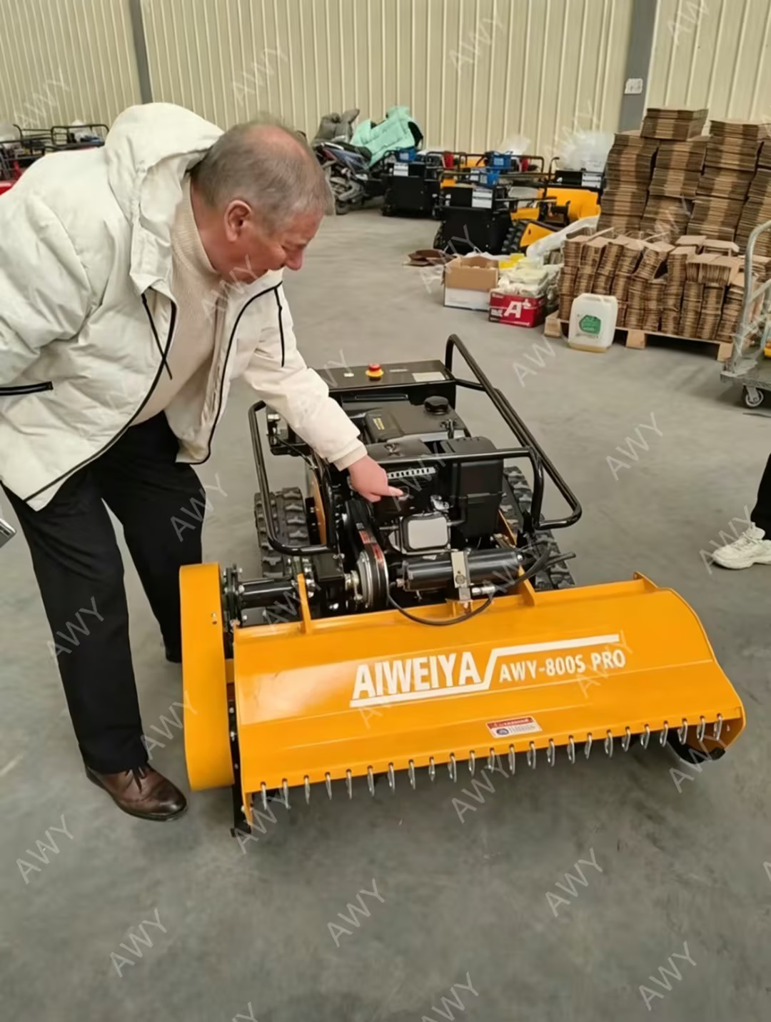 Customer checking delivered remote flail mower in factory
